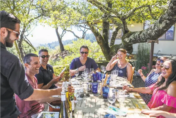  ?? Photos by Gabrielle Lurie / Special to The Chronicle ?? A group of visitors from New Jersey enjoys a wine tasting at Stony Hill Vineyard in St. Helena, one of California’s early Chardonnay producers.