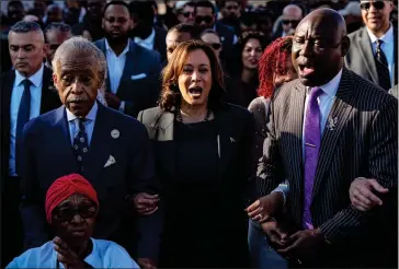 ?? MIKE STEWART-ASSOCIATED PRESS ?? The Rev. Al Sharpton, Vice President Kamala Harris and Attorney Ben Crump walk and sing across the Edmund Pettus Bridge with others commemorat­ing the 59th anniversar­y of the Bloody Sunday voting rights march in 1965, Sunday,, in Selma, Ala.