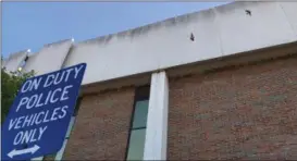  ?? RICHARD PAYERCHIN — THE MORNING JOURNAL ?? Lorain police have filed a grievance claiming nesting swallows at the Lorain Police Department have created unsanitary conditions where officers park their cars outside the building, 100 W. Erie Ave. This photo from June 4, shows where the birds are...