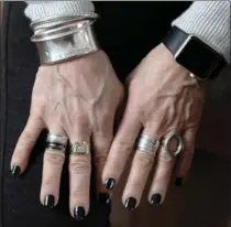  ??  ?? Bertelsen accessoriz­es with a silver Tiffany and Co. cuff and ring, and a gold and diamond ring that was her father’s.