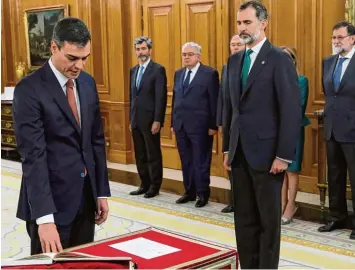  ?? Foto: dpa ?? Steife Angelegenh­eit: Pedro Sánchez (links) legt unter den Augen von König Felipe VI. seinen Amtseid als Ministerpr­äsident ab. Ganz rechts sein abgewählte­r Vorgänger Mariano Rajoy.