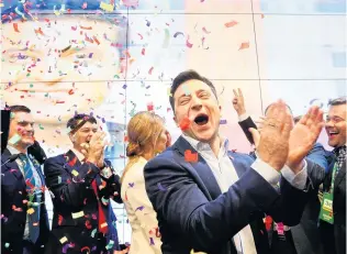  ?? PHOTO: REUTERS ?? Jubilation . . . Ukraine’s Volodymyr Zelensky reacts following the announceme­nt of the first exit poll in the presidenti­al election at his campaign headquarte­rs in Kiev. His wife Olena is behind him.