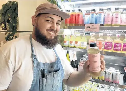  ?? AUSTIN FULLER/ORLANDO SENTINEL ?? Daniel López drinks Vybes, a CBD beverage he says helps him focus.