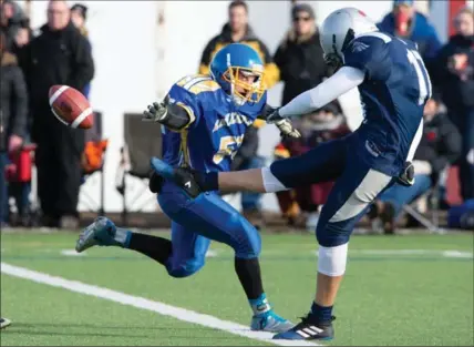  ?? MATHEW MCCARTHY, RECORD STAFF ?? Jacob Hespeler kicker Dylan Rasmussen gets the ball up and away as Grand River Renegades’ Matt Morgado tries to block the punt Saturday during the WCSSAA football final Saturday. The Hawks beat the Renegades, 32-1.