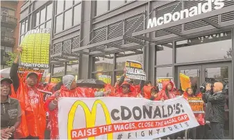  ?? STEFANO ESPOSITO/ SUN- TIMES ?? Protesters march outside the McDonald’s headquarte­rs in theWest Loop.