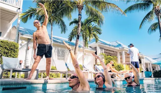  ?? MARK HEDDEN/THE NEW YORK TIMES ?? Peter Rogers teaches an aqua yoga class, put on hiatus during the coronaviru­s pandemic, Feb. 13 at the Marker Key West Harbor Resort in Key West, Florida.