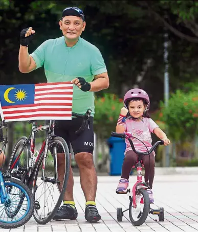  ??  ?? On the right track: With the Jalur Gemilang held proudly, Hakim poses with Amir and Iris Amelin along with their bicycles.