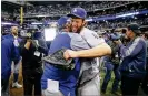  ?? JONATHAN DANIEL / GETTY IMAGES ?? Dodgers ace Clayton Kershaw celebrates Saturday after Los Angeles beat Milwaukee 5-1 to return to the World Series as National League champ.