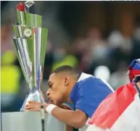  ?? (AP FOTO/LUCA BRUNO) ?? Kylian Mbappé besa el trofeo de campeón.