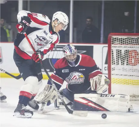  ?? DAX MELMER ?? Windsor’s Egor Afanasyev misses on a scoring opportunit­y against the Saginaw Spirit’s Marshall Frappier Thursday at the WFCU Centre.