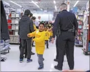  ?? CHRIS BARBER — DIGITAL FIRST MEDIA ?? Jovanny Aquino is greeted by high fives from deputies and volunteers as he enters Walmart on Saturday.