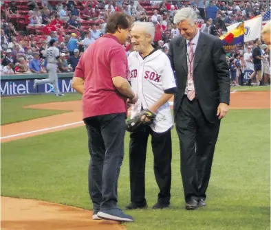  ??  ?? Roland Hemond, flanked by Tony La Russa, left, and Dave Dombrowski, is honoured before a Boston Red Sox game earlier this month. Columnist Bill Young is co-authoring a biography on Hemond, who has deep Quebec roots.