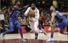  ?? TONY DEJAK — THE ASSOCIATED PRESS ?? The Cavaliers’ Dwyane Wade drives to the basket between the Magic’s Terrence Ross, left, and Evan Fournier in the first half.