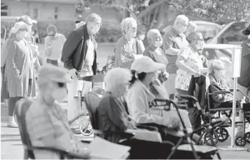  ?? SUSAN STOCKER/SOUTH FLORIDA SUN SENTINEL PHOTOS ?? John Knox Village residents line up to receive their first dose of the Pfizer COVID-19 vaccine on Tuesday in Pompano Beach.