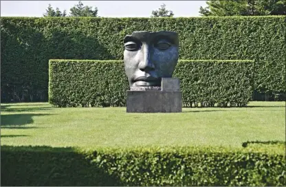  ?? Charles Mayer/AP ?? The sculpture ‘Per Adriano’ by sculptor Igor Mitoraj is displayed in a residentia­l garden on the east end of Long Island in New York. The garden was designed by landscape architect Edmund Hollander.