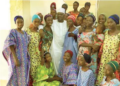  ?? PHOTO CREDIT: Muhammed Hussain ?? The recently freed Chibok schoolgirl­s in a group picture with Senator Ali Ndume (Borno South) in Abuja yesterday