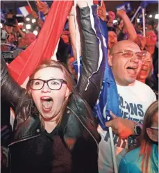  ?? FRANK AUGSTEIN, AP ?? Supporters of far-right leader Marine Le Pen celebrate in Henin Beaumont as she led all contenders in Sunday’s voting, a result that drew a rowdy gathering of protesters in Paris.