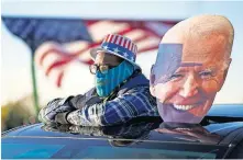  ?? HARNIK/ THE ASSOCIATED PRESS] ?? A supporter watches as Democratic presidenti­al candidate former Vice President Joe Biden and former President Barack Obama speak at a rally Saturday at Belle Isle Casino in Detroit, Mich. [ANDREW