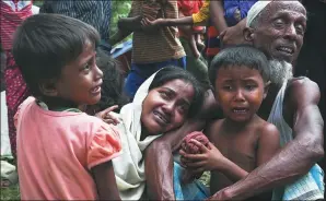  ?? MUSHFIQUL ALAM / ASSOCIATED PRESS ?? A group of Muslim Rohingyas in Ghumdhum, Cox's Bazar, weep as Bangladesh border guards (not pictured) prevent them from entering the country and order them to leave their makeshift camp on Monday.