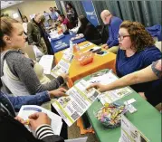  ?? JEFF MOREHEAD / CHRONICLE-TRIBUNE ?? People seek employment at a job fair in Indiana in early April. Economists surveyed by the National Associatio­n for Business Economics expect improved or unchanged sales and profits at their companies in the second quarter.