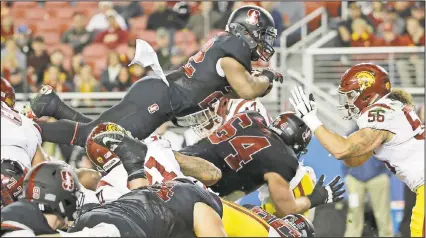  ??  ?? Stanford running back Remound Wright leaps over the pile as he tries to score but comes up short.