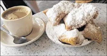  ?? LIGAYA FIGUERAS PHOTOS / LFIGUERAS@AJC.COM ?? Ligaya Figueras’ family had Cafe Du Monde’s famous cafe au lait and beignets in New Orleans.