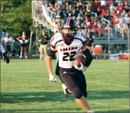  ?? Staff photo/Corey Maxwell ?? Fort Loramie’s Damon Mescher runs around the left side Friday night in the Redskins opening game against Minster.