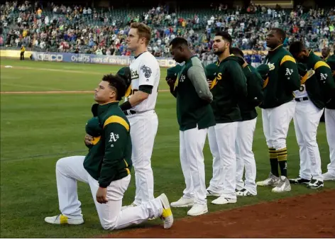  ?? AP Photo/Eric Risberg ?? In this 2017 file photo, Oakland Athletics catcher Bruce Maxwell kneels during the national anthem before the start of a baseball game against the Texas Rangers in Oakland, Calif.