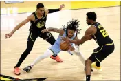  ?? KARL MONDON — BAY AREA NEWS GROUP ?? Memphis Grizzlies’ Ja Morant battles for the ball while defended by Golden State Warriors’ Jordan Poole and Andrew Wiggins in the fourth quarter of Game 3of a second-round NBA basketball playoff series at Chase Center in San Francisco on Saturday.