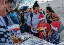  ?? Jessica Phelps/staff photograph­er ?? Migrants in San Antonio enjoy a meal on Christmas Eve provided by residents who heard that some had gone days without properly eating. San Antonio is a city with a heart.