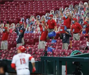  ?? (AP/Aaron Doster) ?? Members of the Cincinnati Reds’ grounds crew react as Joey Votto runs the bases after hitting a two-run home run during Wednesday’s game against the Milwaukee Brewers in Cincinnati.