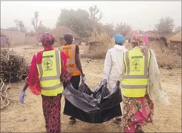  ?? Jossy Ola Associated Press ?? THE BODY of one of the victims of a Boko Haram suicide attack is taken away in Maiduguri, Nigeria. The Islamic extremists attacked two villages on the outskirts of the city late Sunday, Nigeria’s military said.