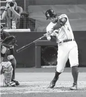  ?? JAE C. HONG AP ?? Houston’s George Springer hits a two-run home run against Tampa Bay during the fifth inning in Game 4 of the ALCS at Petco Park on Wednesday night.