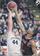  ?? Adrian Kraus / Special to the Times Union ?? Lake George’s Chris Becker, left, tries to shoot over Middle Early College’s Ja’kari Nettles during their Class C semifinal on Saturday.