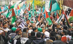  ?? Bilal Hussein / Associated Press ?? Protesters chant slogans as they hold Palestinia­n flags during a demonstrat­ion in front of the U.S. embassy in Aukar, east of Beirut, on Sunday. A few hundred demonstrat­ors, including Palestinia­ns, pelted security outside the embassy with stones and...