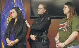  ?? Dania Maxwell Los Angeles Times ?? AN OFFICER consoles the family of Gardiel Solorio, who was killed Monday in Downey, during a news conference at L.A.’s Hall of Justice on Wednesday.