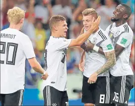  ?? AP ?? (From left) Germany's Julian Brandt, Joshua Kimmich and Antonio Ruediger (extreme right) congratula­te Toni Kroos after he scored the decisive goal in the 21 win over Sweden.