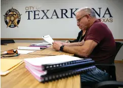  ?? Staff photo by Hunt Mercier ?? ■ Tim Minson from Cohen-Esrey Developmen­t Group reviews the bids for the Hotel Grim contract Monday at Texarkana, Texas, City Hall.