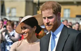  ?? — AFP ?? Prince Harry, Duke of Sussex ( R), and his wife, Meghan, Duchess of Sussex, attend the Prince of Wales’ 70th Birthday Garden Party at Buckingham Palace in London on May 22, 2018