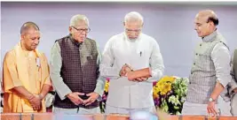  ?? PTI ?? Prime Minister Narendra Modi with Union Home Minster Rajnath Singh, UP Governor Ram Naik and Chief Minister Yogi Adityanath at a ground breaking ceremony to launch various projects worth 60,000 crore rupees, at Indira Gandhi Pratishtha­n in Lucknow on Sunday