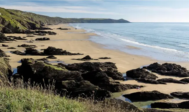  ??  ?? Sharrow Point juts out to sea from Whitsand Bay, with the tiny pimple that is St Michael’s Chapel just visible on the furthest seaward peak.