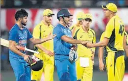 ?? PTI PHOTO ?? MS Dhoni and Manish Pandey with Australian players after India won the third ODI in Indore on Sunday to take an unassailab­le 30 lead in the fivematch series.