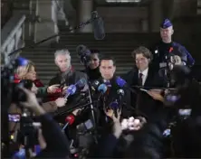  ?? Olivier Matthys/Associated Press ?? Michalis Dimitrakop­oulos, center right, and Andre Risopoulos, center left, lawyers for former European Parliament Vice President Eva Kaili, speak with the media at the courthouse in Brussels on Dec. 22. She has been charged in relation with the scandal, which involves influencin­g Qatari and Moroccan officials with gifts and money.