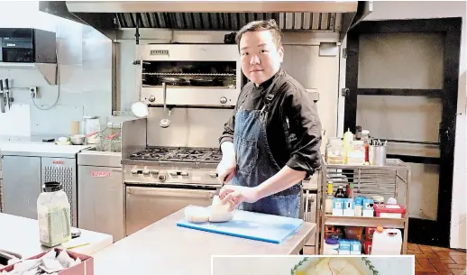  ?? SPECIAL TO TORSTAR ?? Paul Bang, who owns Korean BBQ Town in St. Catharines, slices a head of napa cabbage for kimchee in his restaurant kitchen.