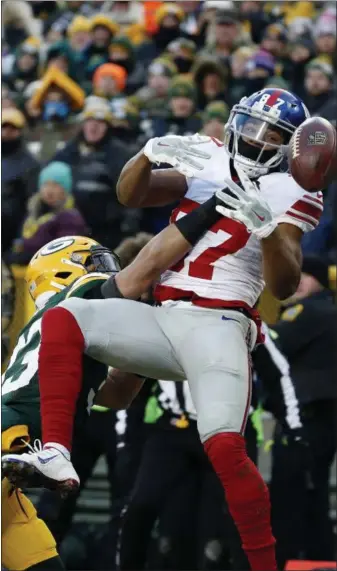  ?? MIKE ROEMER — THE ASSOCIATED PRESS ?? Green Bay Packers strong safety Micah Hyde (33) breaks up a pass intended for New York Giants wide receiver Sterling Shepard (87) during the first half of an NFC wild-card game on Sunday in Green Bay.