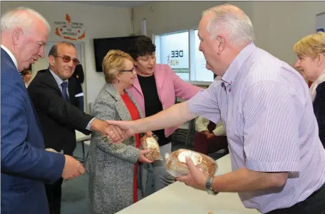  ??  ?? No brown envelopes here just brown bread and sausages. John Caffrey and Mary Meade present Bank of Ireland Enterprisi­ng Town judges Tom Hayes, John Fitzgerald and Eileen Collery with some home made Ardee produce during their visit to Dee Hub in Ardee.