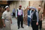  ??  ?? Iraqi actors act out a scene of a parody sketch video adaptation of Bab Al-Hara.