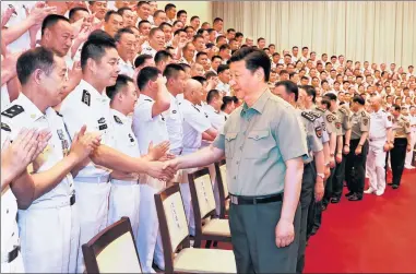 ?? ZHA CHUNMING / XINHUA ?? President Xi Jinping, who also is chairman of the Central Military Commission, greets officers of the People’s Liberation Army Navy on Wednesday during his visit to naval headquarte­rs in Beijing.