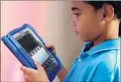  ?? Mark Lennihan Associated Press ?? VTECH will pay $650,000 to settle federal claims. Above, a child uses one of the company’s e-readers.