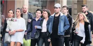  ??  ?? Family and friends cross the road from Tup Tup Palace to St Nicholas Cathedral to attend a candlelit vigil for Paul Burns